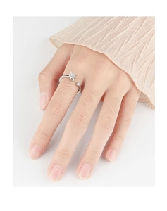 Close-up of a silver adjustable star ring with zircons on a model's finger