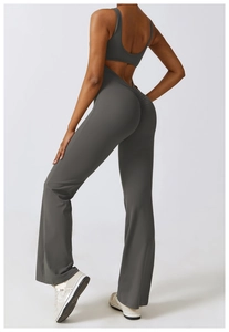 Deep grey backless yoga jumpsuit featuring scrunch butt detail and flared leg design