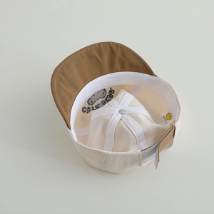 Close-up of baby baseball cap interior showing soft sweatband and adjustable velcro strap