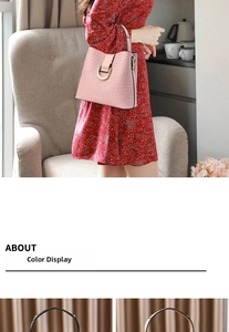 Detail of pink faux leather bucket bag featuring crocodile pattern and gold D-ring buckle