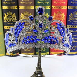 Detailed macro of silver bridal crown featuring blue crystals on a mini Eiffel tower stand