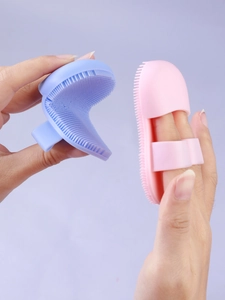 Flexible silicone finger face brushes in pink and blue for deep pore cleansing and massage
