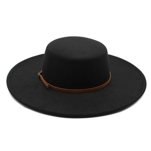 Detail of black wool felt flat top boater hat with a brown leather band and gold buckle