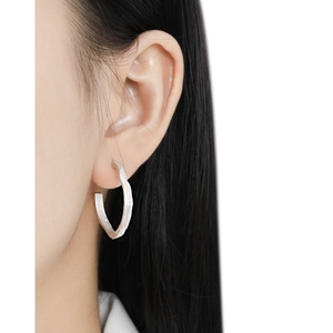 Irregular textured S925 sterling silver geometric hoop earrings on female model