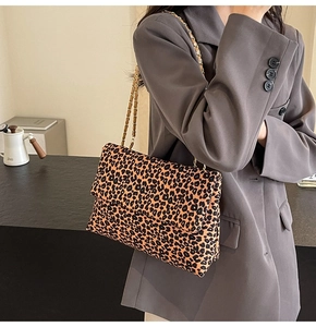 Close-up of leopard print shoulder bag with elegant gold chain strap detail