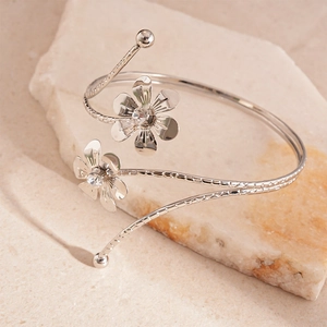 Close-up of silver-tone flower open bangle with crystal centers and spiral texture