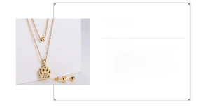 Detail of 18k gold plated stainless steel hollow dog paw pendant and double chain