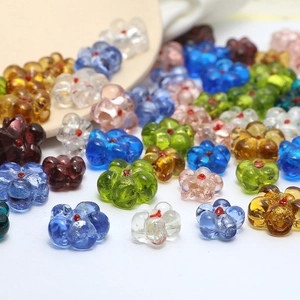 Macro shot of colorful flower-shaped glass beads for DIY jewelry making accessories