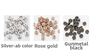 Macro shot of silver, rose gold and black spacers with embedded rhinestone crystals