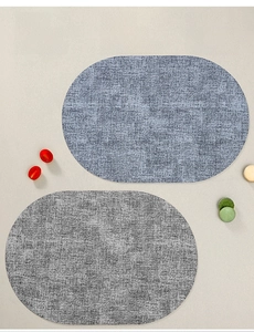 Detail of grey woven textured oval placemats with waterproof and heat-resistant material