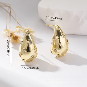 Detail showing dimensions of gold water drop earrings with white zircon heart inlays