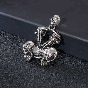 Detailed shot of silver engine skull pendant with intricate biker and rocker metal textures