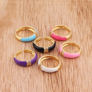 Macro detail of colorful enamel rings with gold plating and sparkling zircon inlay