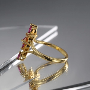 Elegant 18K gold ring with cluster of pink marquise-cut stones in a floral butterfly shape