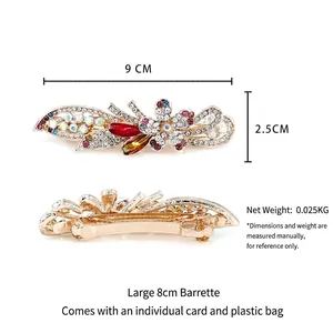 Floral spring hair clip with red and purple rhinestones on a golden metal base, 9cm long