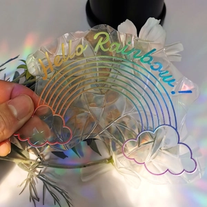 Rainbow suncatcher window film with Hello Rainbow design creating holographic light patterns
