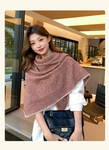 Detailed view of thick knit wavy pattern scarf in brown and white winter shawl style