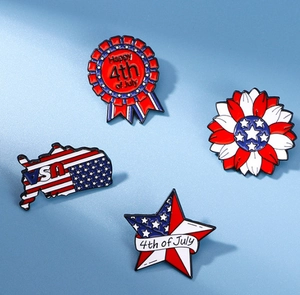 Detail showing 4th of July enamel pins with USA flag patterns and patriotic motifs