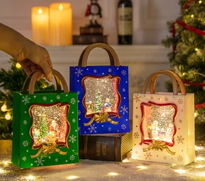 Close-up of three festive lantern handbags with swirling glitter and Santa scenes