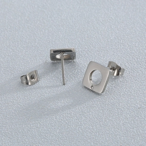 Detail showing square stainless steel stud earrings with center circular cut-out design