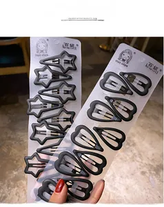 Close-up of matte black hair clips in star and water-drop shapes on a display card