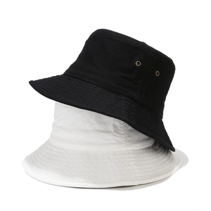 Detailed view of breathable metal eyelets on classic black and white cotton bucket hats