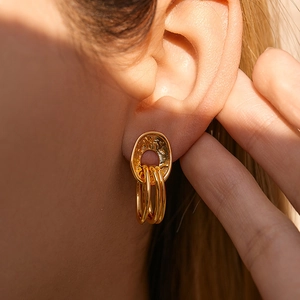Chic 18K gold plated overlapping heart-shaped dangle earrings for women on model