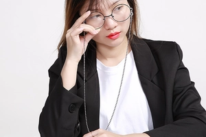 Silver beaded chain for sunglasses styled on a model with a professional outfit