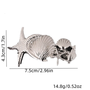 Detailed view of starfish and seashell hair clip showing dimensions 7.5cm and 4.3cm