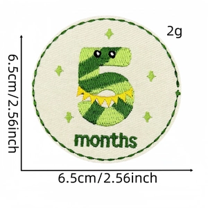 Detail of 6.5cm embroidered baby milestone patch with green dinosaur and number 5