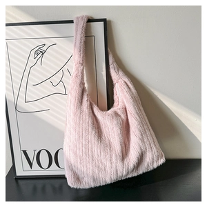Detailed view of pink faux fur tote bag featuring vertical striped texture in soft light