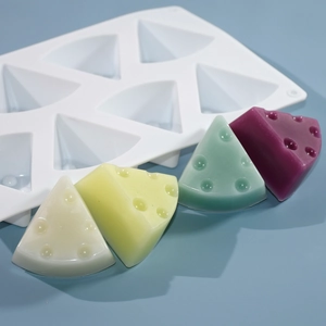 8-cavity cheese slice silicone mold with colorful resin and soap samples on blue background