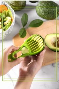 Detailed view of the 3-in-1 avocado slicer cutting fruit on a wooden board