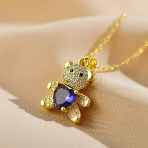 Macro shot of teddy bear pendant with purple heart stone and micro-pave zircons