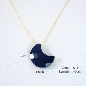 Detail showing 1.9x1.6cm black crescent moon pendant on a 14K gold plated chain