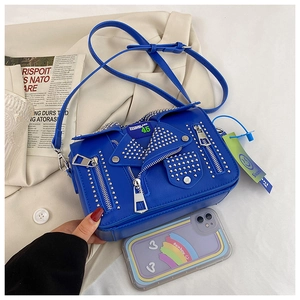 Detail of royal blue biker jacket crossbody bag with silver studs and zipper accents