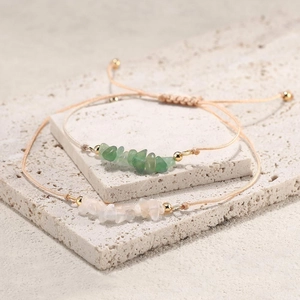 Set of two natural crushed stone woven bracelets in green and opal white with gold beads