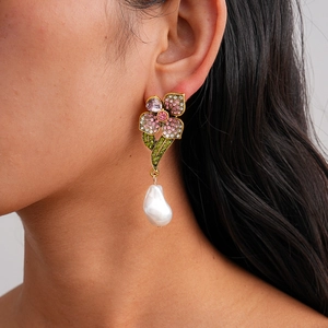 Detail of luxury flower drop earring with pink crystals and a white baroque pearl