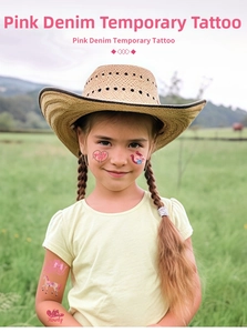 Pink cowgirl temporary tattoo with heart and horseshoe motifs shown on a child's arm