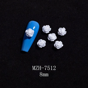 Detail showing an 8mm white 3D resin camellia flower charm on a blue nail tip model