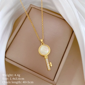 Detailed view of luxury cat-eye key pendant necklace on a beige jewelry display