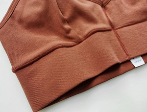 Close-up of brown ribbed knit sports bra showing soft cotton texture and seamless stitching
