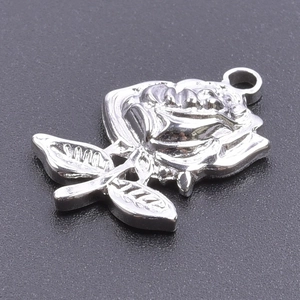 Macro view of a silver rose flower pendant with leaves and hanging ring on dark background