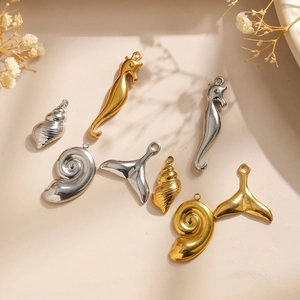 Detailed arrangement of 18K gold and silver plated ocean charms featuring seahorse and shell