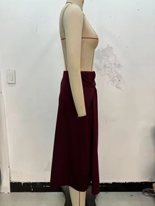 Detail shot of elegance burgundy A-line skirt featuring a minimalist side-twist knot design