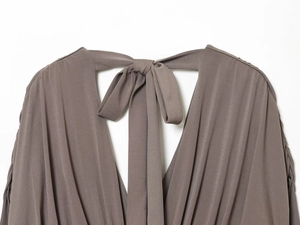 Detail of V-neckline with bow tie and ribbed texture on taupe puff sleeve mini dress