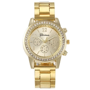 Macro detail of gold-tone Geneva quartz watch with rhinestone bezel and metal link bracelet