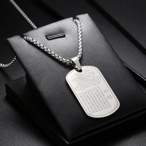 Macro view of silver titanium steel dog tag pendant with lotus and Heart Sutra engraving