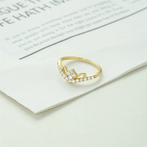 Detailed macro view of S925 sterling silver stamp on golden crown ring with zircons