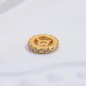 Macro shot of S925 sterling silver gold-plated wheel bead with pavé white zircon stones